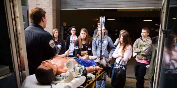 A paramedic gives students a tour of his emergency vehicle.
